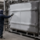 Technician spray applying thermal insulation coating AES TECH to an industrial furnace